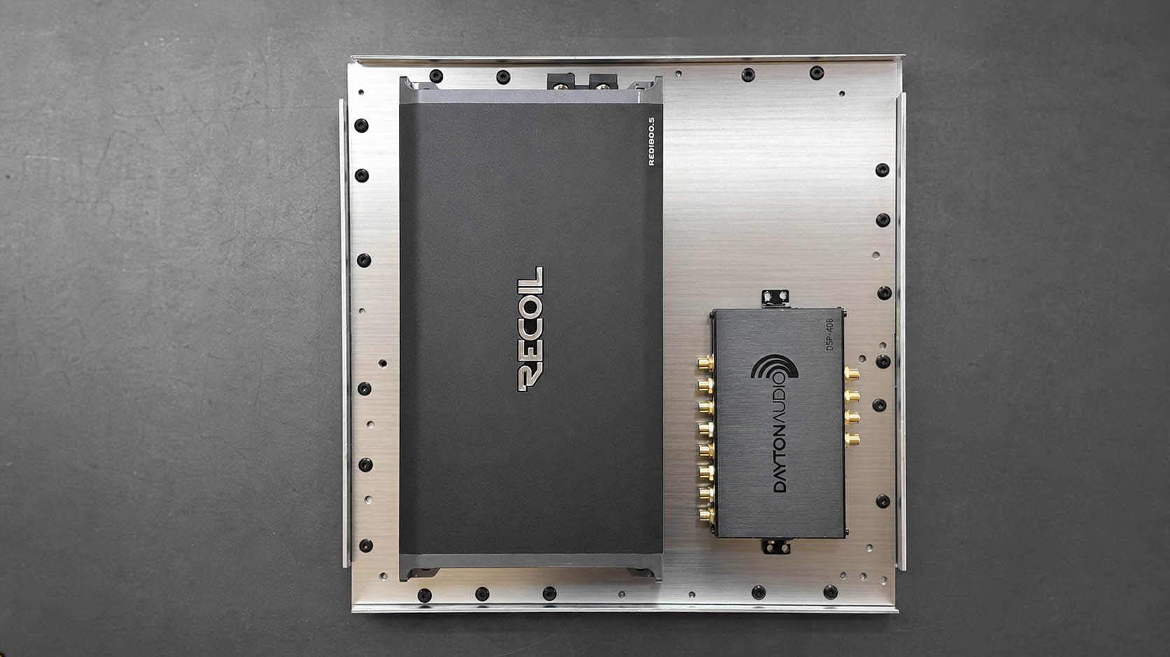 Top view of a prototype amplifier and DSP mounting drawer on an aluminum panel.